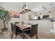 A dining area with a wooden table, modern lighting, and view of the kitchen at 4849 Cypress Woods Dr # 1308, Orlando, FL 32811