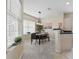 Modern dining room with stylish pendant lighting, wood table, seating, and large windows with natural light at 4849 Cypress Woods Dr # 1308, Orlando, FL 32811
