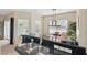 An open-concept kitchen featuring stainless steel appliances, sink, black countertops, and bright light at 4849 Cypress Woods Dr # 1308, Orlando, FL 32811