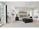 Open-concept living room with access to the kitchen and bedrooms, featuring a comfy sofa and ceiling fan at 4849 Cypress Woods Dr # 1308, Orlando, FL 32811