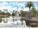 Scenic pond view with a fountain, lush landscaping, and clear blue skies offering a serene outdoor ambiance at 4849 Cypress Woods Dr # 1308, Orlando, FL 32811