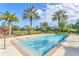Inviting community pool surrounded by palm trees and manicured landscaping, offering a refreshing outdoor space at 4849 Cypress Woods Dr # 1308, Orlando, FL 32811