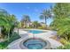 Relaxing pool area with a hot tub and tropical landscaping, providing a luxurious and serene outdoor retreat at 4849 Cypress Woods Dr # 1308, Orlando, FL 32811