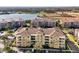 Aerial view of the property showcasing the balconies and surrounding complex, and lake at 5025 Shoreway Loop # 20503, Orlando, FL 32819