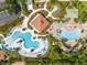 Aerial view showcasing pools, umbrellas, and lush landscaping in this resort-style community at 5025 Shoreway Loop # 20503, Orlando, FL 32819
