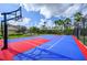 Bright community basketball court with well-maintained surface, surrounded by lush landscaping and palm trees at 5025 Shoreway Loop # 20503, Orlando, FL 32819