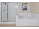 Clean bathroom with a glass-enclosed shower and a large soaking tub for relaxation at 5025 Shoreway Loop # 20503, Orlando, FL 32819