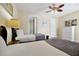 Bright bedroom with two twin beds, a ceiling fan, and a view of the en-suite bathroom at 5025 Shoreway Loop # 20503, Orlando, FL 32819