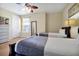 Comfortable bedroom featuring two twin beds, a ceiling fan, and natural light from the window at 5025 Shoreway Loop # 20503, Orlando, FL 32819