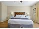 Cozy bedroom with a king-size bed, bedside tables with lamps, and wood-look flooring at 5025 Shoreway Loop # 20503, Orlando, FL 32819