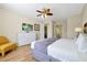 Comfortable bedroom featuring a king bed, dresser, TV, and adjacent bathroom access for convenience at 5025 Shoreway Loop # 20503, Orlando, FL 32819