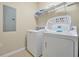 A well-equipped laundry room with a washer, dryer, wire shelving, and tiled floors at 5025 Shoreway Loop # 20503, Orlando, FL 32819