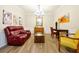 Elegant living room with wood floors, a red leather sofa, and decorative paintings on the wall at 5025 Shoreway Loop # 20503, Orlando, FL 32819