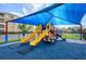 Community playground with covered play structure, slides, and benches for relaxing while play at 5025 Shoreway Loop # 20503, Orlando, FL 32819