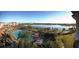 Scenic view of the Vista Cay pool area, complete with sun loungers, palm trees, and a view of the tranquil lake at 5025 Shoreway Loop # 20503, Orlando, FL 32819