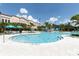 Inviting swimming pool area with clear blue water, surrounded by lounge chairs, umbrellas, and lush landscaping at 5025 Shoreway Loop # 20503, Orlando, FL 32819