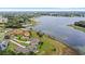 Aerial view of homes near a serene lake surrounded by lush greenery at 534 Two Lakes Ln, Eustis, FL 32726