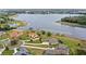 Aerial view of beautiful homes near a serene lake, surrounded by lush greenery and serene waters at 534 Two Lakes Ln, Eustis, FL 32726
