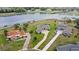 An aerial view of a set of homes near a pond with lush landscaping and long driveways at 534 Two Lakes Ln, Eustis, FL 32726