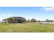 Large backyard lawn with screened in patio and lake at 534 Two Lakes Ln, Eustis, FL 32726