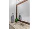Bathroom featuring vanity with granite countertop, framed mirror and modern fixtures at 534 Two Lakes Ln, Eustis, FL 32726