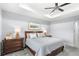 Serene bedroom showcasing a tray ceiling, soft lighting, and neutral color palette at 534 Two Lakes Ln, Eustis, FL 32726