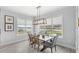 Bright dining room with view of water, a modern light fixture, and a table for six at 534 Two Lakes Ln, Eustis, FL 32726