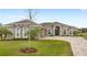 Well-manicured front lawn and extended driveway leading to this gorgeous home with a stunning facade at 534 Two Lakes Ln, Eustis, FL 32726