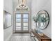 Elegant foyer with a console table, mirror, vases, and wood-look tile flooring at 534 Two Lakes Ln, Eustis, FL 32726