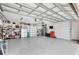 A well lit three car garage with plenty of storage and epoxy flooring at 534 Two Lakes Ln, Eustis, FL 32726
