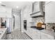 This spacious kitchen features white cabinets, stainless steel appliances, and a stylish tile backsplash at 534 Two Lakes Ln, Eustis, FL 32726