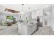 Open kitchen with large island, stainless steel appliances, and views to the living room at 534 Two Lakes Ln, Eustis, FL 32726