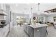 Kitchen with center island, pendant lights, adjacent dining area, and connection to the living room at 534 Two Lakes Ln, Eustis, FL 32726