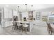 Well-lit open kitchen with island seating, modern appliances, and adjacent dining area at 534 Two Lakes Ln, Eustis, FL 32726