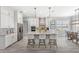Bright, open kitchen with white cabinetry, a large island, and stainless steel appliances at 534 Two Lakes Ln, Eustis, FL 32726