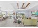 Open-concept floor plan featuring a tray ceiling, large fan, and a bar in the kitchen at 534 Two Lakes Ln, Eustis, FL 32726
