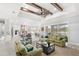Spacious living room with beautiful ceiling beams, windmill fan, and comfortable seating at 534 Two Lakes Ln, Eustis, FL 32726
