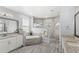 This main bathroom includes a soaking tub, tiled shower with glass enclosure, and dual sink vanity at 534 Two Lakes Ln, Eustis, FL 32726