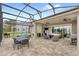 Spacious outdoor patio with a covered area and screened-in seating with lake view at 534 Two Lakes Ln, Eustis, FL 32726
