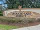 Stone community sign for Crooked Lake Reserve surrounded by manicured landscaping at 534 Two Lakes Ln, Eustis, FL 32726