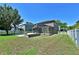 Expansive backyard features a screened lanai, a stone firepit, and a large grassy area at 535 Belle Fern Ct, Ocoee, FL 34761