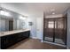 Bathroom with a double vanity sink, walk-in shower with glass doors, and a neutral color palette at 535 Belle Fern Ct, Ocoee, FL 34761