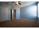 Bedroom with blue walls, carpet flooring, and closet at 535 Belle Fern Ct, Ocoee, FL 34761