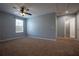 Bedroom with carpet flooring, a ceiling fan, and a window for natural light at 535 Belle Fern Ct, Ocoee, FL 34761
