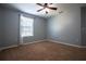 Bedroom featuring carpet, a ceiling fan, and a window with curtains at 535 Belle Fern Ct, Ocoee, FL 34761