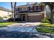 Inviting two-story home with brick driveway, two-car garage, solar panels and tasteful landscaping at 535 Belle Fern Ct, Ocoee, FL 34761