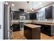 Kitchen featuring dark cabinets, stainless steel appliances, and a center island at 535 Belle Fern Ct, Ocoee, FL 34761