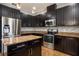 An open kitchen with a large refrigerator, oven, dishwasher, and a center island at 535 Belle Fern Ct, Ocoee, FL 34761