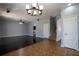 Open concept living area with tile and vinyl plank flooring, staircase, and overhead lighting at 535 Belle Fern Ct, Ocoee, FL 34761