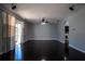 Open living room with a fan, a sliding glass door, and vinyl plank flooring at 535 Belle Fern Ct, Ocoee, FL 34761